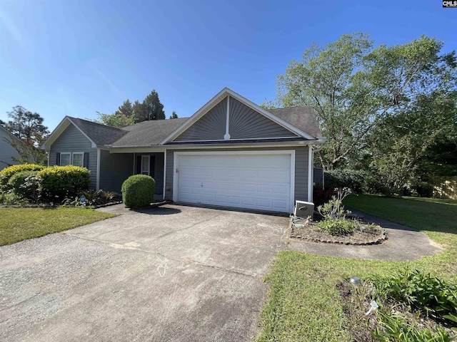 ranch-style home featuring roof with shingles, an attached garage, concrete driveway, and a front lawn
