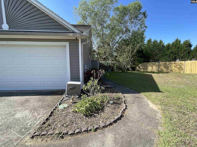 exterior space featuring fence and a garage