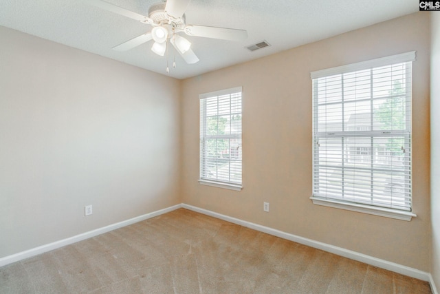 unfurnished room featuring visible vents, carpet flooring, and baseboards