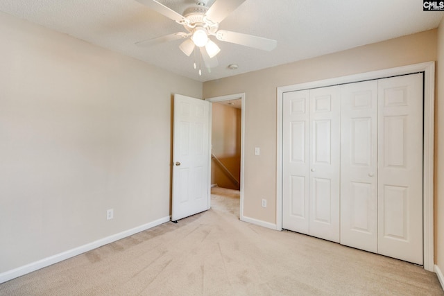 unfurnished bedroom featuring carpet flooring, a ceiling fan, baseboards, and a closet