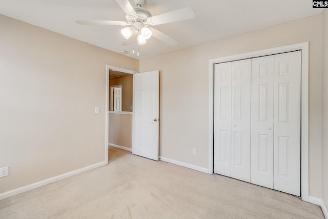 unfurnished bedroom featuring carpet flooring, baseboards, ceiling fan, and a closet