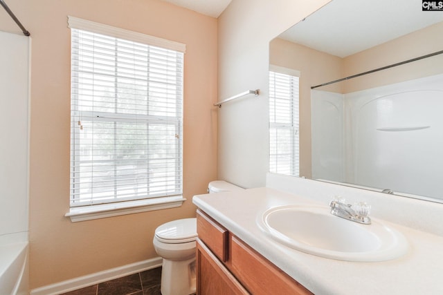 full bath with vanity, baseboards, toilet, and a wealth of natural light