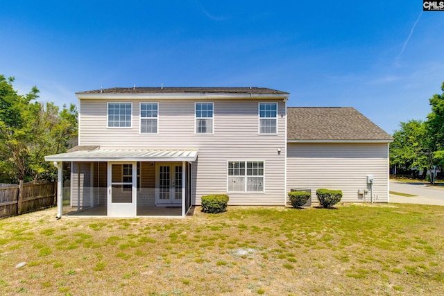 rear view of house featuring fence, a yard, a patio area, and french doors