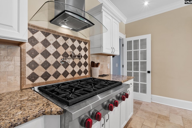 kitchen with wall chimney range hood, crown molding, light stone countertops, white cabinets, and stainless steel gas cooktop