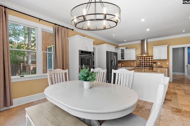 dining area featuring a notable chandelier, recessed lighting, baseboards, ornamental molding, and stone tile flooring