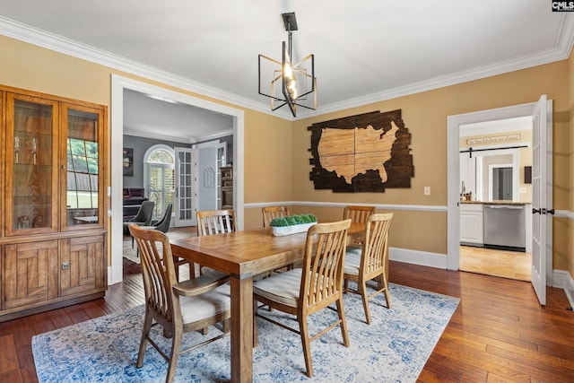 dining area with baseboards, a chandelier, ornamental molding, and dark wood finished floors