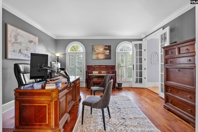 office featuring crown molding, french doors, plenty of natural light, and wood finished floors