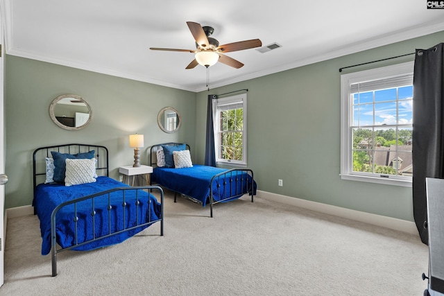 bedroom featuring crown molding, ceiling fan, carpet floors, baseboards, and visible vents