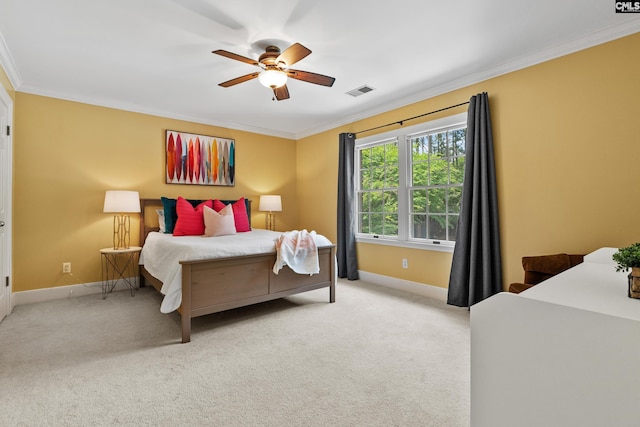 bedroom with carpet flooring, baseboards, visible vents, and ornamental molding