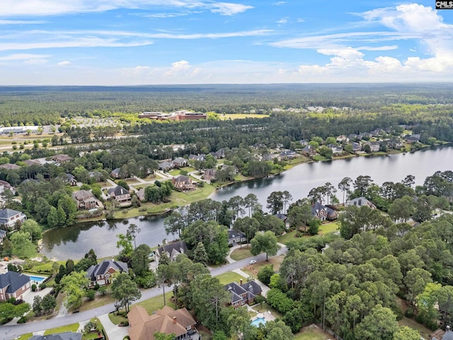 drone / aerial view with a water view, a view of trees, and a residential view