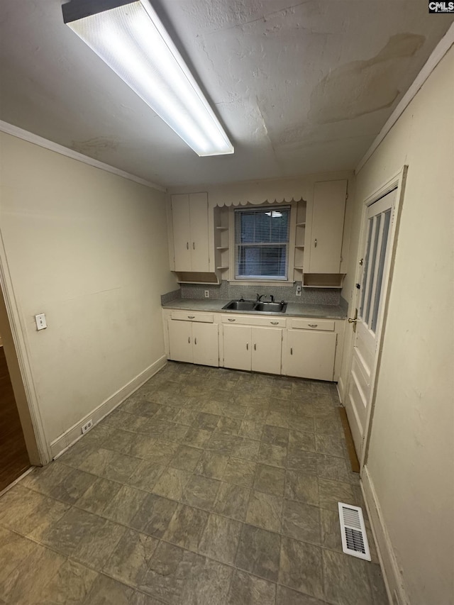 4906 Bethel Church Rd, Columbia, SC 29206 - kitchen with visible vents, open shelves, baseboards, white cabinetry, and a sink