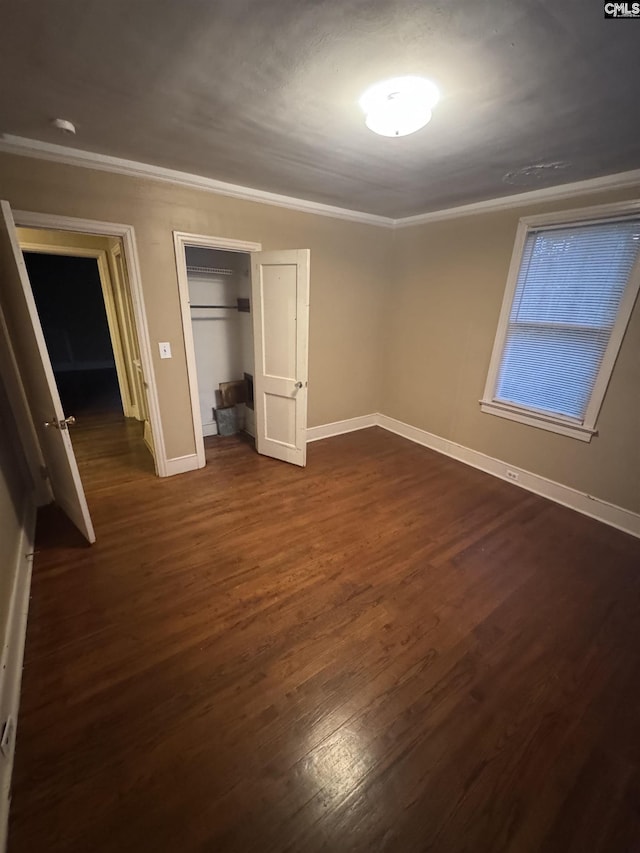 4906 Bethel Church Rd, Columbia, SC 29206 - unfurnished bedroom with crown molding, a closet, baseboards, and dark wood-type flooring