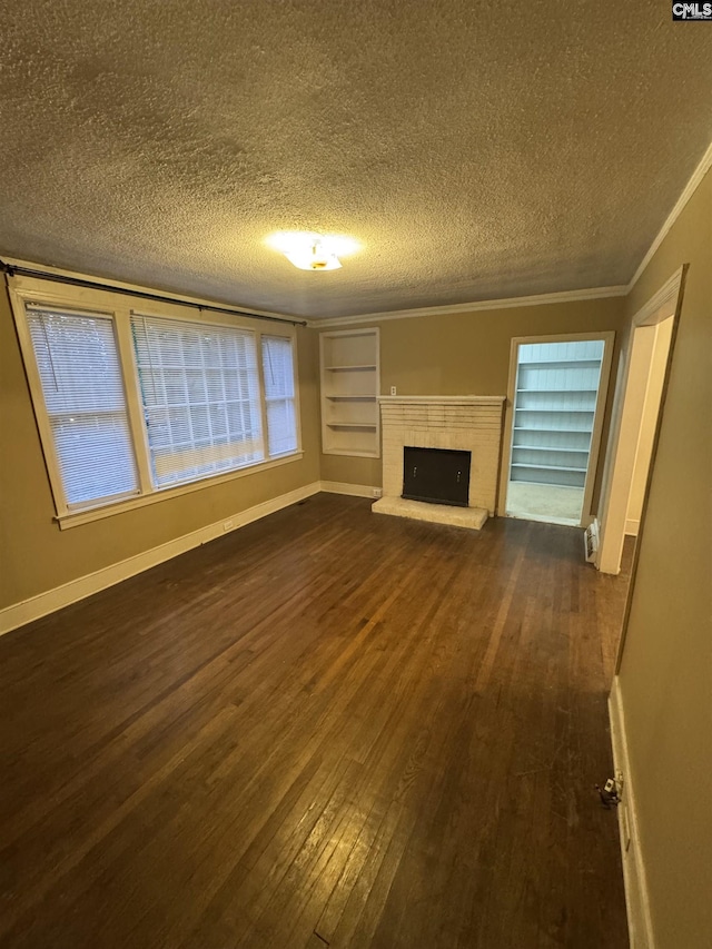 4906 Bethel Church Rd, Columbia, SC 29206 - unfurnished living room featuring crown molding, dark wood-style flooring, a fireplace, baseboards, and a textured ceiling