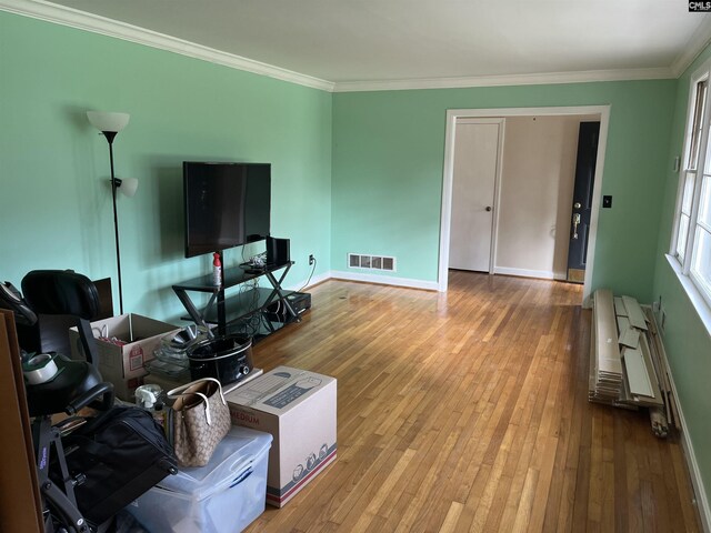 906 Brantley St, Columbia, SC 29210 - living room featuring baseboards, visible vents, ornamental molding, and hardwood / wood-style flooring