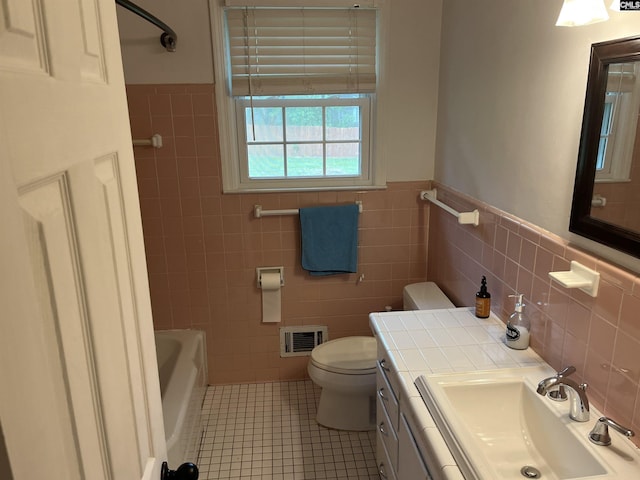 906 Brantley St, Columbia, SC 29210 - bathroom with wainscoting, tile patterned flooring, toilet, tile walls, and visible vents