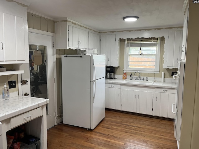 906 Brantley St, Columbia, SC 29210 - kitchen featuring freestanding refrigerator, dark wood-style flooring, tile counters, white cabinetry, and a sink