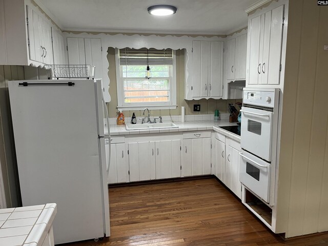 906 Brantley St, Columbia, SC 29210 - kitchen with white appliances, tile countertops, a sink, and dark wood-type flooring