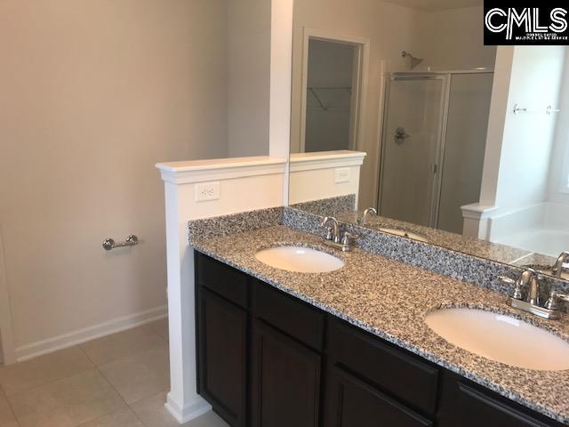 730 Lansford Bay Dr, West Columbia, SC 29172 - bathroom with double vanity, a sink, and a stall shower