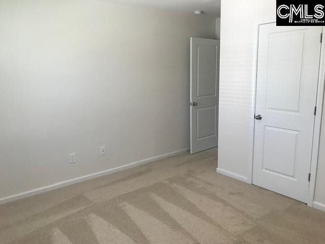 730 Lansford Bay Dr, West Columbia, SC 29172 - unfurnished bedroom featuring baseboards and light carpet