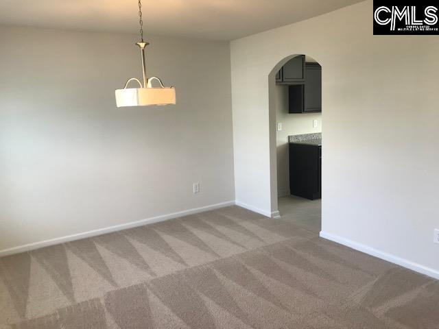 730 Lansford Bay Dr, West Columbia, SC 29172 - spare room featuring baseboards, arched walkways, and light carpet