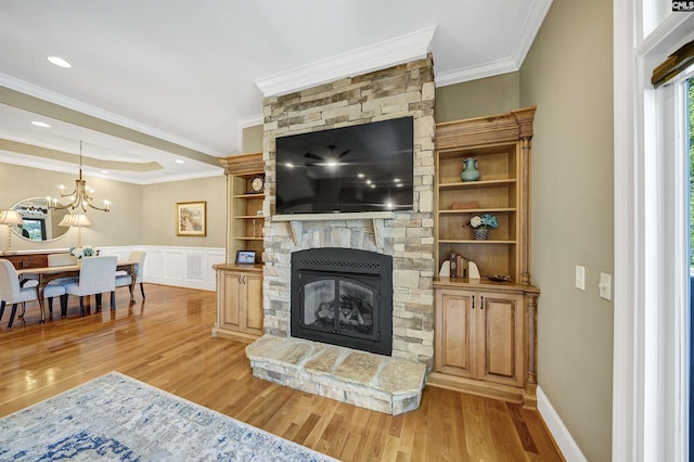 305 Marina Ct, Lexington, SC 29072 - living area with ornamental molding, a fireplace, a wainscoted wall, a chandelier, and light wood-style flooring