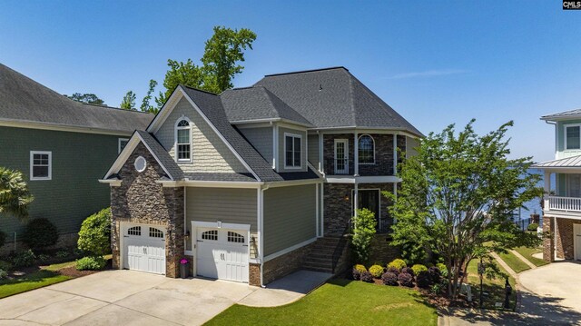 305 Marina Ct, Lexington, SC 29072 - craftsman-style house featuring driveway, roof with shingles, a front lawn, an attached garage, and stone siding