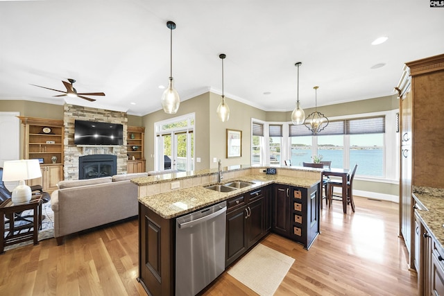 305 Marina Ct, Lexington, SC 29072 - kitchen with ceiling fan, a stone fireplace, dishwasher, a sink, and light wood-style floors