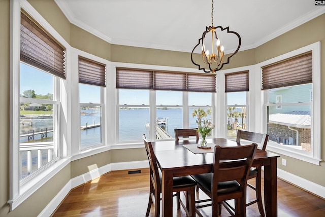 305 Marina Ct, Lexington, SC 29072 - dining area featuring crown molding, a water view, a notable chandelier, and wood finished floors