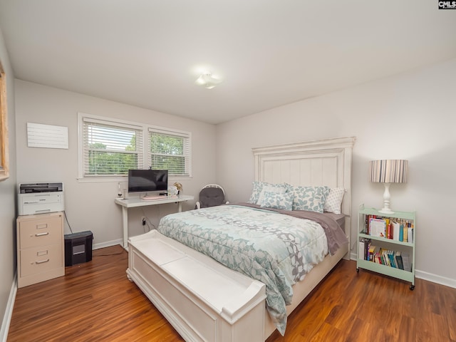 bedroom featuring baseboards and wood finished floors