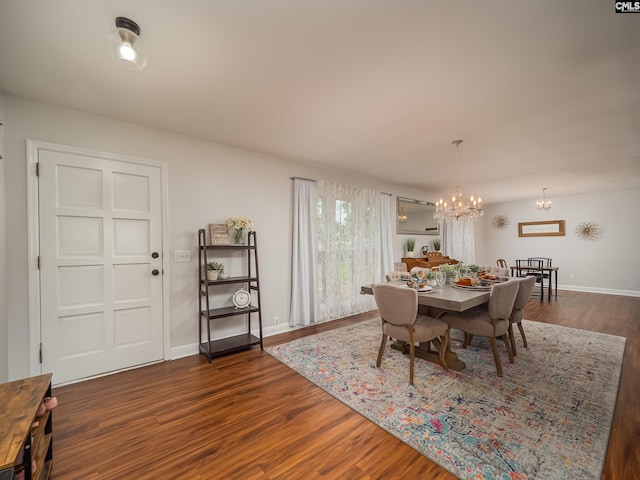 dining area with an inviting chandelier, baseboards, and dark wood-style flooring