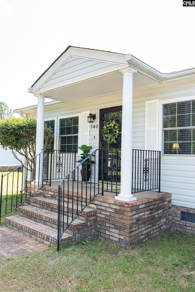 doorway to property featuring covered porch