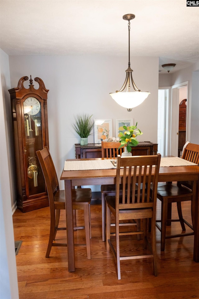 dining area with light wood-style flooring