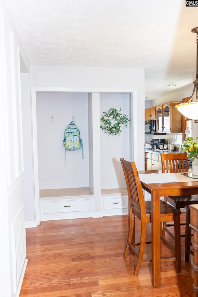 dining area featuring visible vents and light wood-style floors