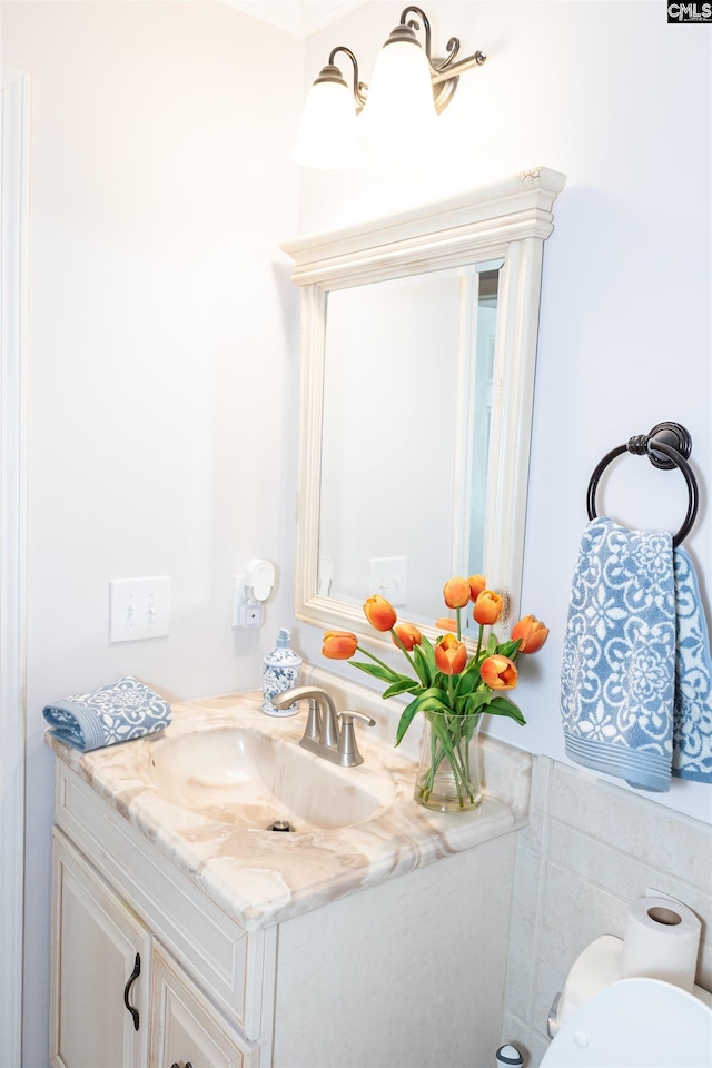 half bathroom with vanity and toilet