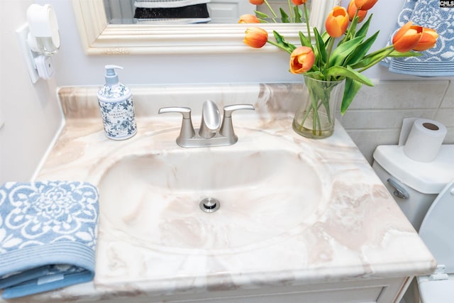 bathroom featuring toilet and vanity