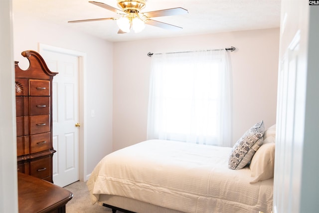 bedroom with a ceiling fan and carpet