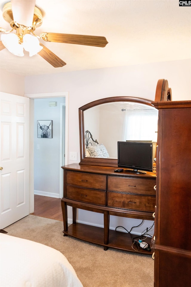 carpeted bedroom with a ceiling fan