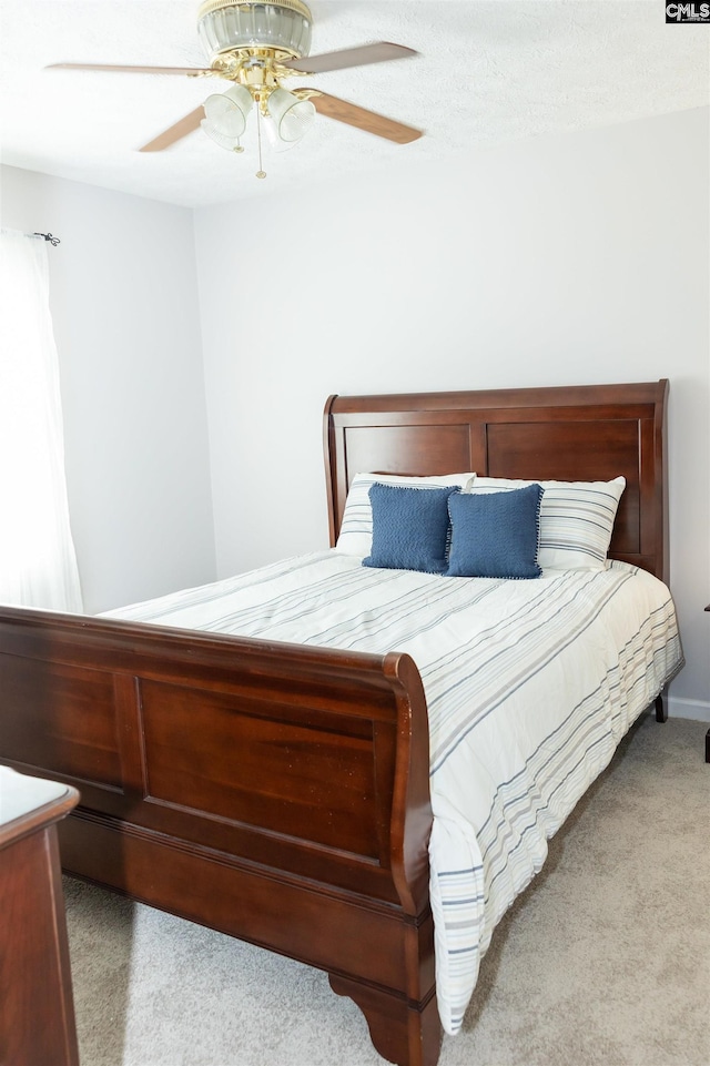 carpeted bedroom with a ceiling fan