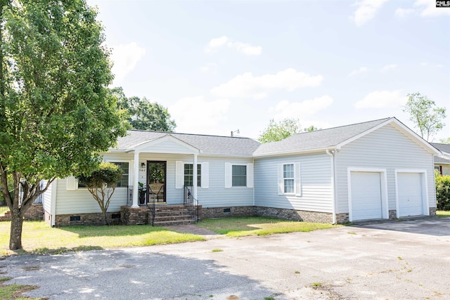ranch-style house with an attached garage, a front lawn, aphalt driveway, and crawl space