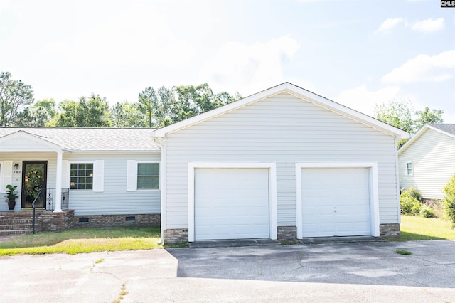 exterior space featuring a detached garage and an outbuilding