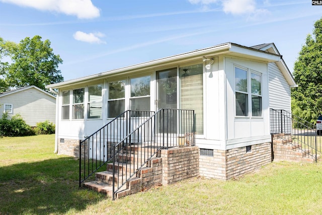 view of front of property with crawl space, stairs, and a front yard