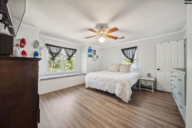 120 Coventry Lake Dr, Lexington, SC 29072 - bedroom featuring wood finished floors, a textured ceiling, ornamental molding, and ceiling fan