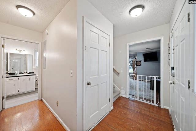 120 Coventry Lake Dr, Lexington, SC 29072 - hallway featuring light wood-style floors, a textured ceiling, and baseboards