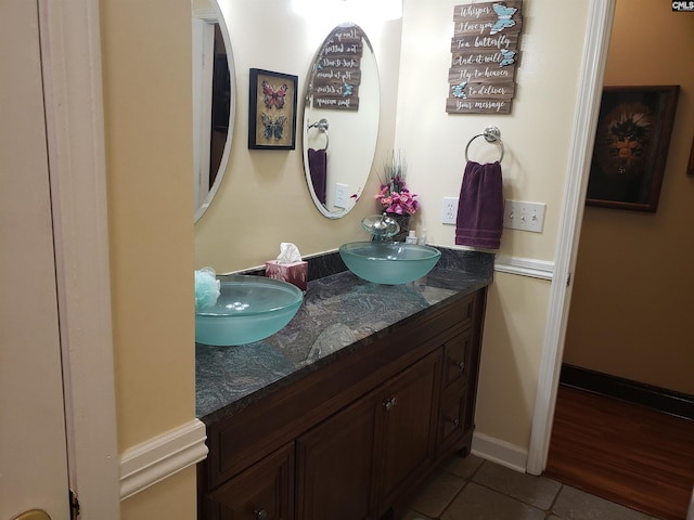 bathroom with double vanity, tile patterned floors, and a sink