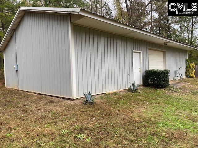 view of side of property with a yard