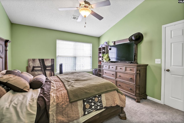 bedroom with visible vents, a textured ceiling, carpet, and lofted ceiling