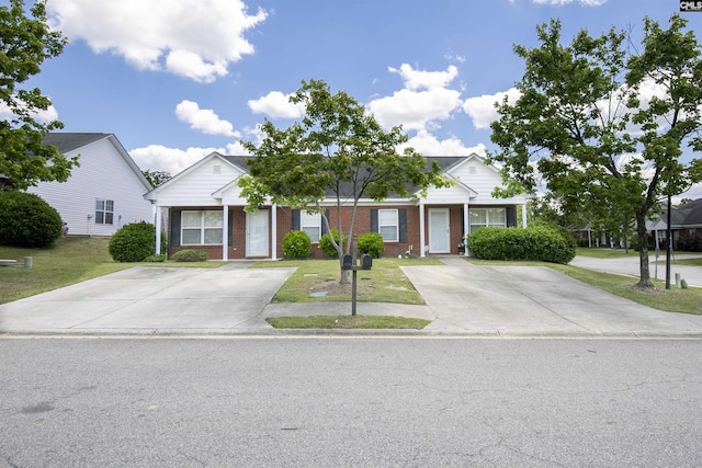 view of front of property with a front yard and brick siding