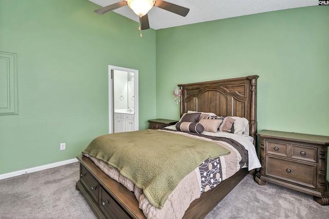 bedroom with connected bathroom, ceiling fan, carpet, baseboards, and a towering ceiling