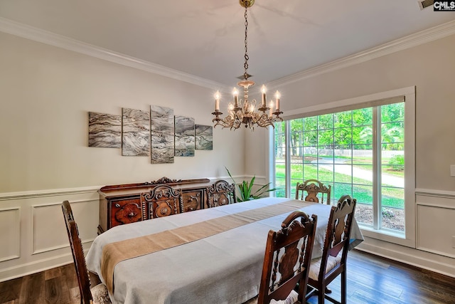 dining space with crown molding, a decorative wall, dark wood-style floors, and a chandelier