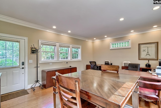 dining room with recessed lighting, ornamental molding, a wealth of natural light, and light wood-style flooring